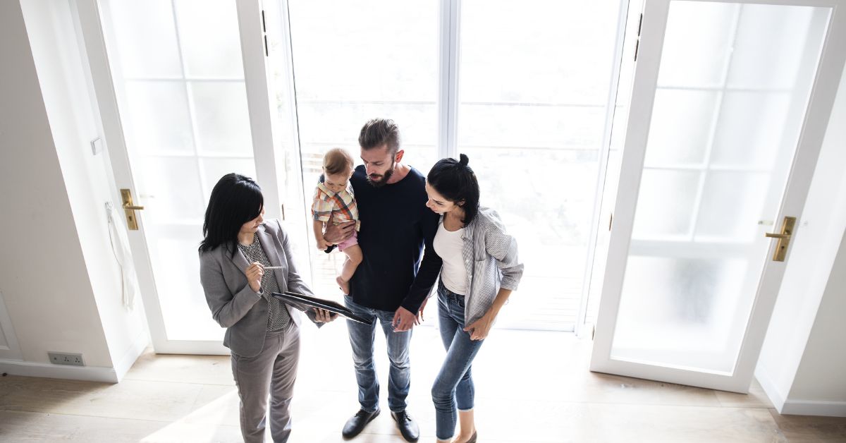 Sellers discussing the sale of their home with their real estate agent.